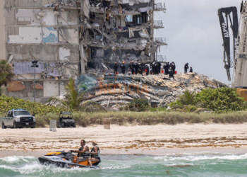 SURFSIDE, FLORIDA - JUNE 26: Members of the South Florida Urban Search and Rescue team look for possible survivors in the partially collapsed 12-story Champlain Towers South condo building on June 26, 2021 in Surfside, Florida. Over 150 people are being reported as missing as search-and-rescue efforts continue with rescue crews from across Miami-Dade and Broward counties. (Photo by Joe Raedle/Getty Images)