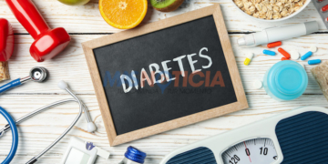 Word Diabetes and diabetic accessories on wooden background