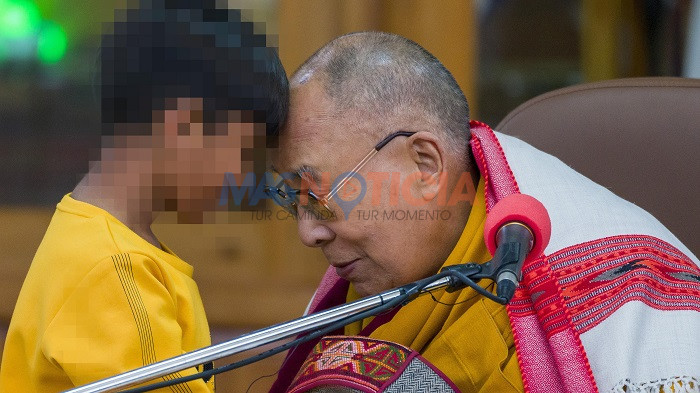 Tibetan spiritual leader the Dalai Lama touches foreheads with a young boy before addressing a group of students at the Tsuglakhang temple in Dharamshala, India, Tuesday, Feb. 28, 2023. (AP Photo/Ashwini Bhatia)